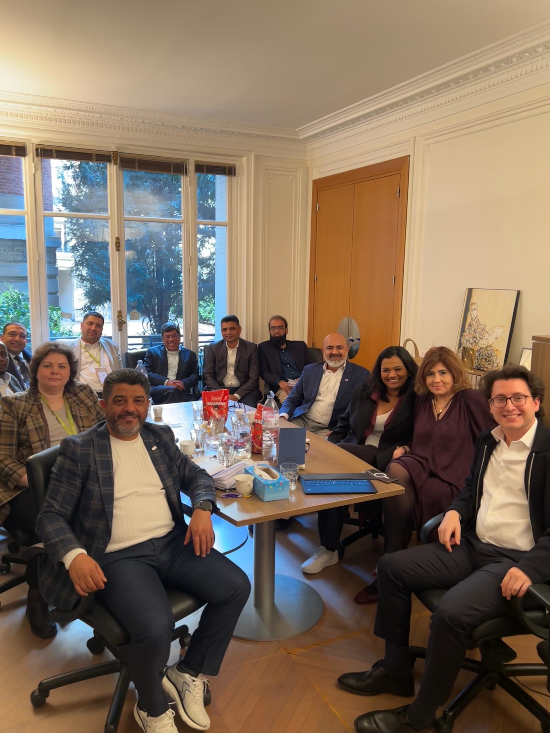 Group of professionals seated around a conference table in a bright office.
